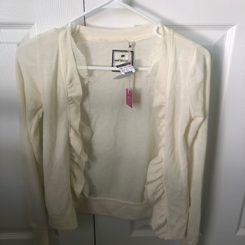 white cardigan with ruffles